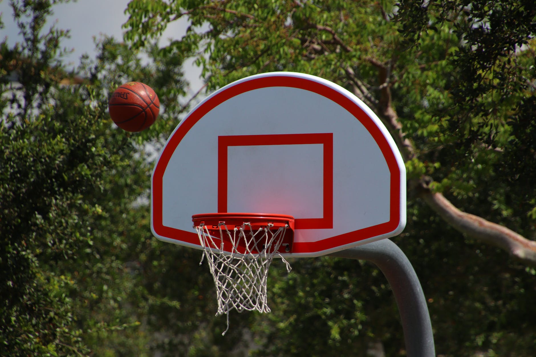 photo of ball near basketball hoop